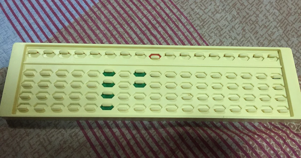 The photo shows a fully molded abacus that uses sliders instead of beads and represents value in the form of color. The value of the abacus is 4025